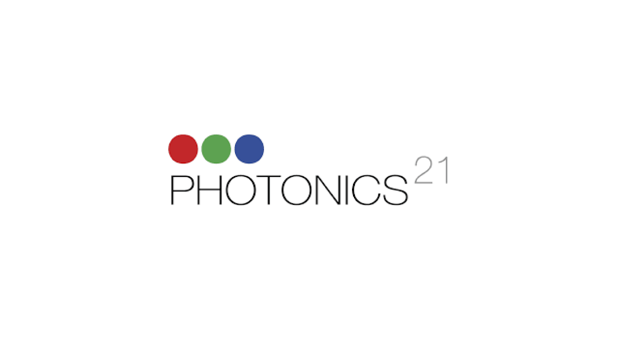 The image shows a logo with the text "PHOTONICS21." Above the text, there are three colored circles in red, green, and blue.