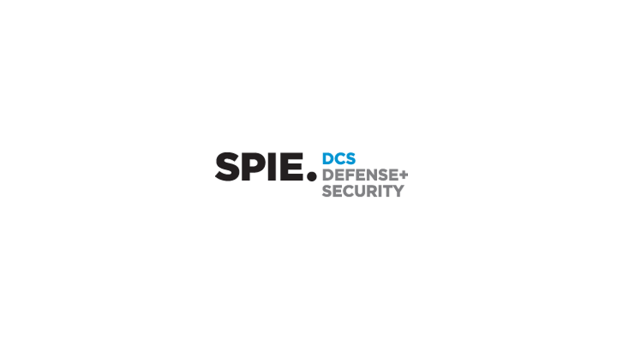 Logo with the text "SPIE DCS Defense + Security" in black and blue letters on a white background.