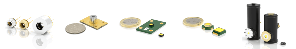 A row of different laser components and sensors, including circular, rectangular, and cylindrical devices, shown next to a coin for size comparison, on a white background.