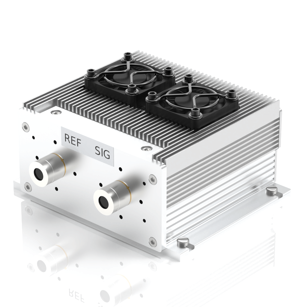 A metallic electronic device with cooling fins, two black cooling fans on top, and labeled ports REF and SIG on the front panel.