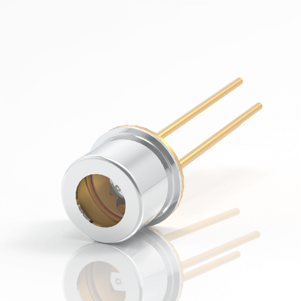 A small cylindrical laser diode with a metallic silver housing and two gold pins extending from one end, placed on a glossy white surface, reflecting its image.
