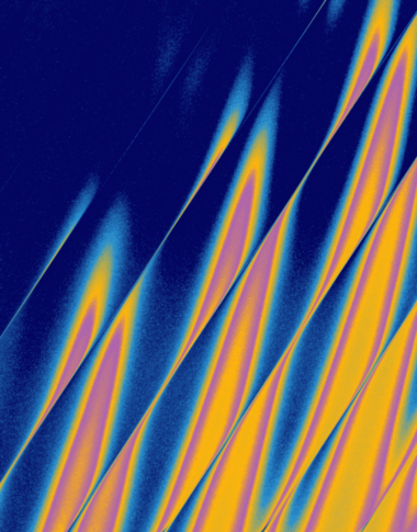 Abstract image with diagonal bands of blue, yellow, and orange, creating a wave-like pattern. The colors blend smoothly, giving a vibrant, energetic effect across the dark background.