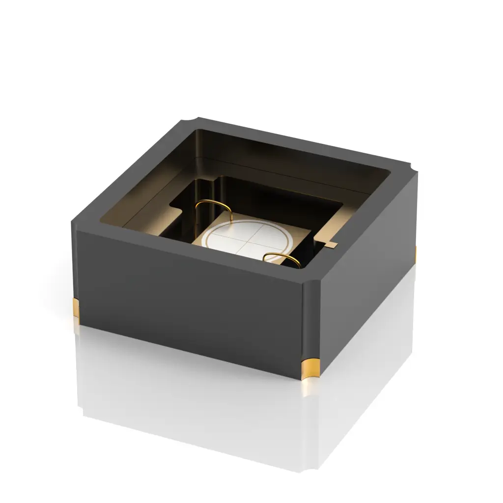 A small, square, black electronic component with gold connectors on its sides and a visible circular element inside, set against a white background.