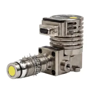 A metallic industrial sensor or electronic component with a yellow-capped end, ribbed cylindrical body, and a rectangular connector on top, featuring a circular port and sharp protrusions.