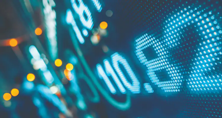A digital display shows numbers in blue and white lights, with a blurred background hinting at data movement or financial stock information. Small orange lights appear on the left side, adding to the vibrant, futuristic scene.