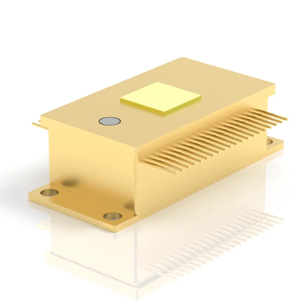 A gold-colored rectangular electronic component with multiple pin connectors on one side, a flat square area on top, and a small circular mark, resting on a white reflective surface.
