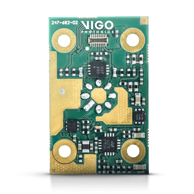 A small green circuit board labeled "VIGO PHOTONICS" featuring various electronic components and four gold circular connectors in each corner.