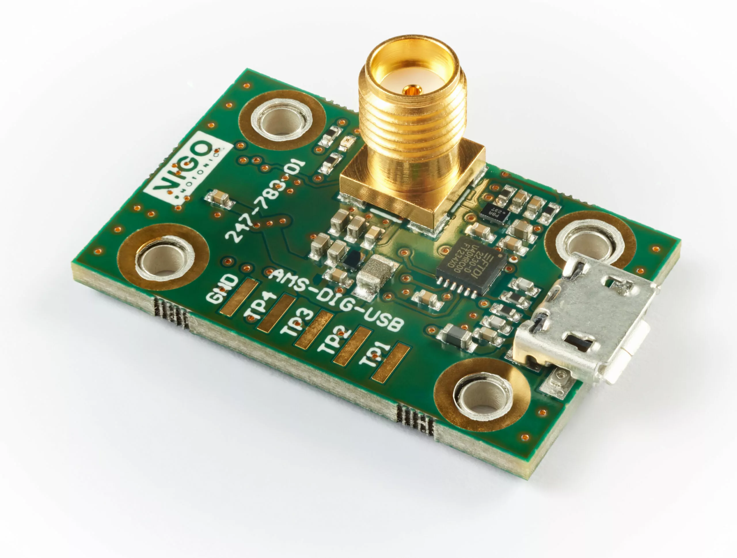 A close-up of a green circuit board with various electronic components, including a central chip and a USB connector on the right. There are four large holes on each corner and a gold SMA connector on top. White text is printed on the board.