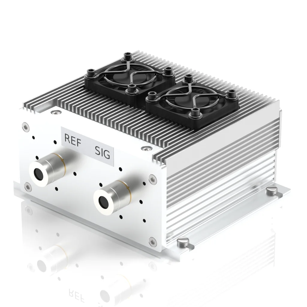 A metallic electronic device with cooling fins, two black cooling fans on top, and labeled ports REF and SIG on the front panel.