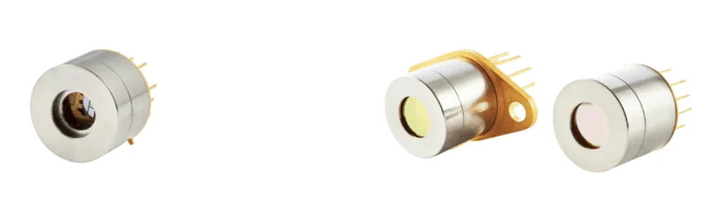 Four metal photodiode sensors with circular lenses and gold pins, arranged in a row on a white background. Each sensor has a slightly different design and casing.